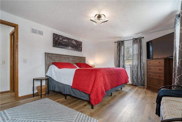 bedroom with hardwood / wood-style floors