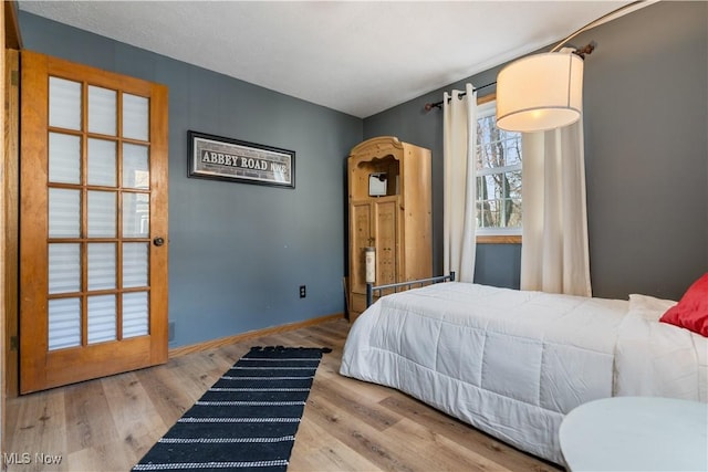 bedroom with hardwood / wood-style floors