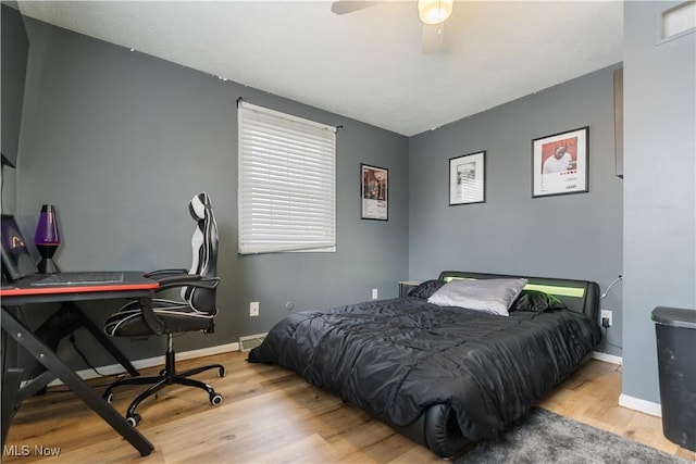 bedroom with ceiling fan and light hardwood / wood-style flooring