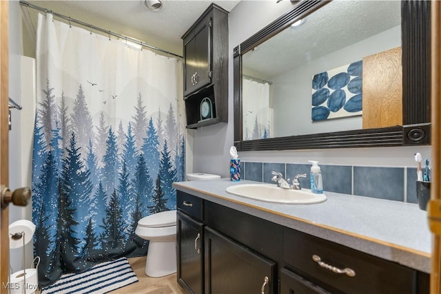 bathroom featuring hardwood / wood-style floors, a textured ceiling, vanity, tasteful backsplash, and toilet