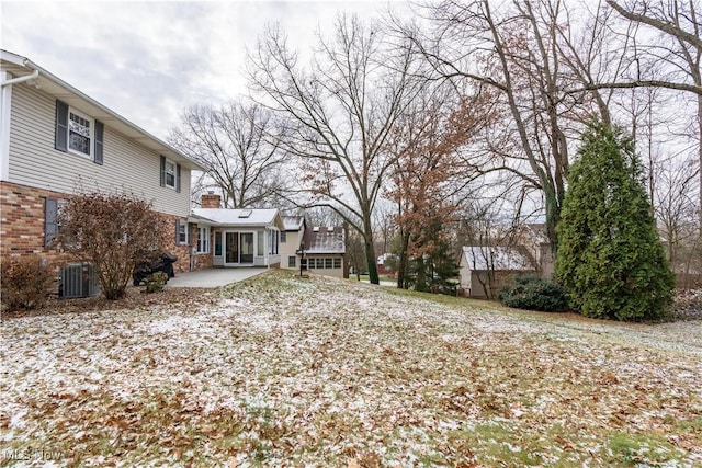 view of yard with central AC unit and a patio area