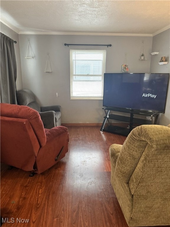 living room with wood-type flooring, a textured ceiling, and crown molding