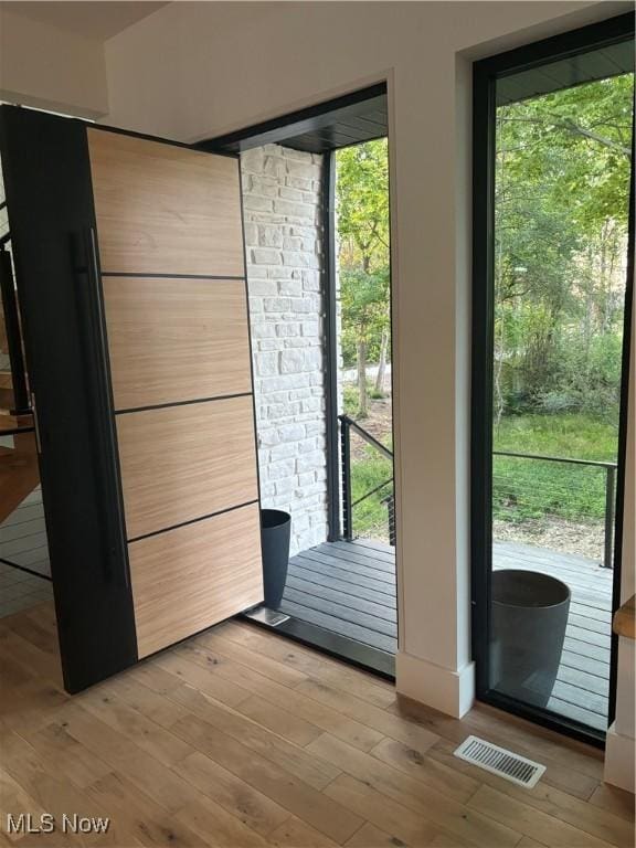 doorway with light hardwood / wood-style flooring