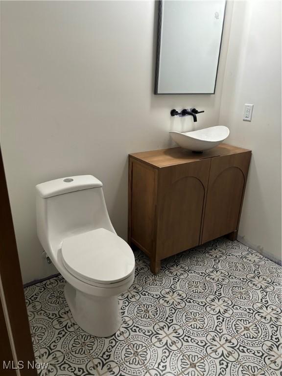 bathroom featuring toilet and vanity