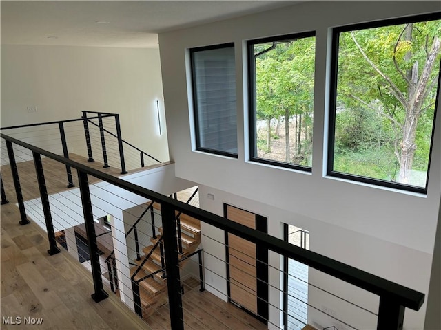 staircase with hardwood / wood-style floors