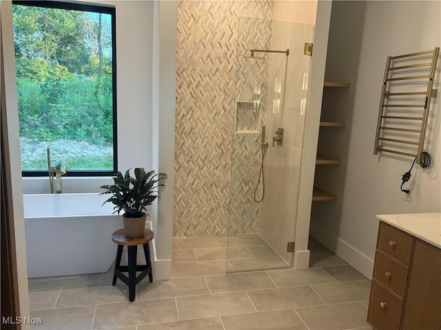 bathroom with tile patterned flooring, separate shower and tub, vanity, and radiator heating unit