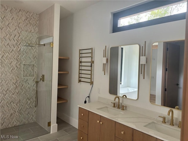 bathroom featuring tile patterned floors, vanity, radiator, and tiled shower