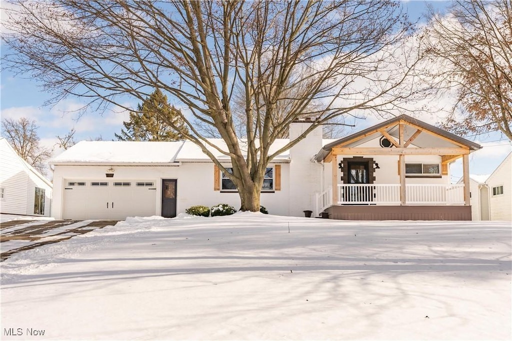 view of front of property featuring a garage and a porch