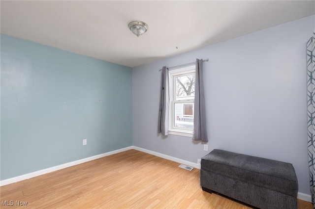 living area with hardwood / wood-style floors