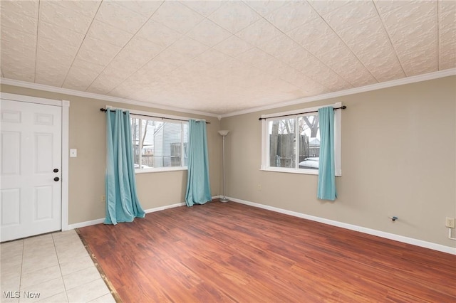 tiled spare room with ornamental molding