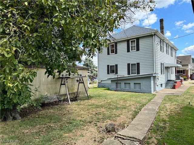 rear view of house with a yard