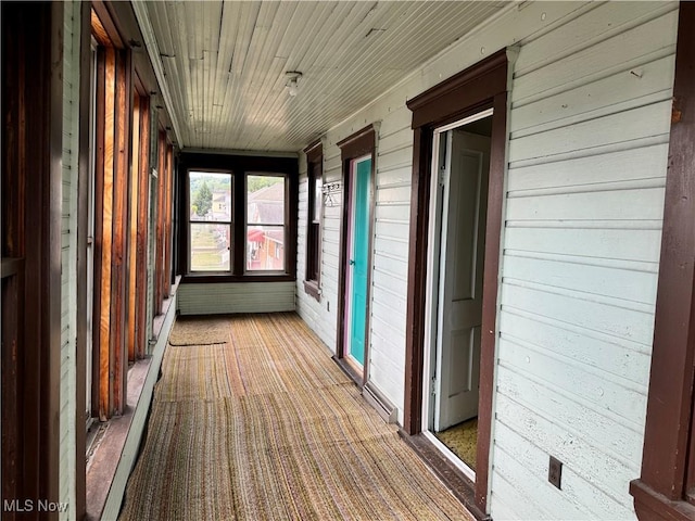 unfurnished sunroom with wooden ceiling