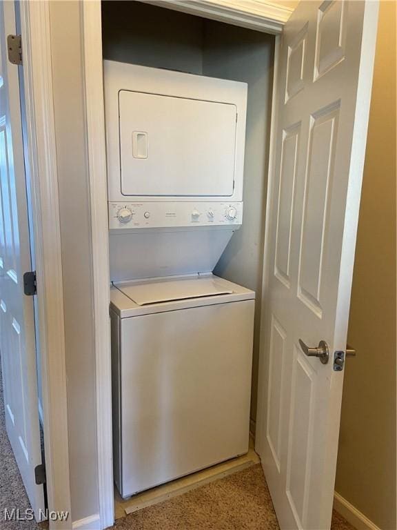 washroom featuring stacked washer / dryer