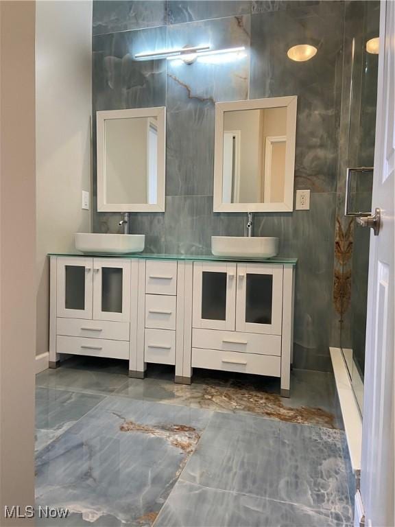 bathroom featuring tile walls and vanity