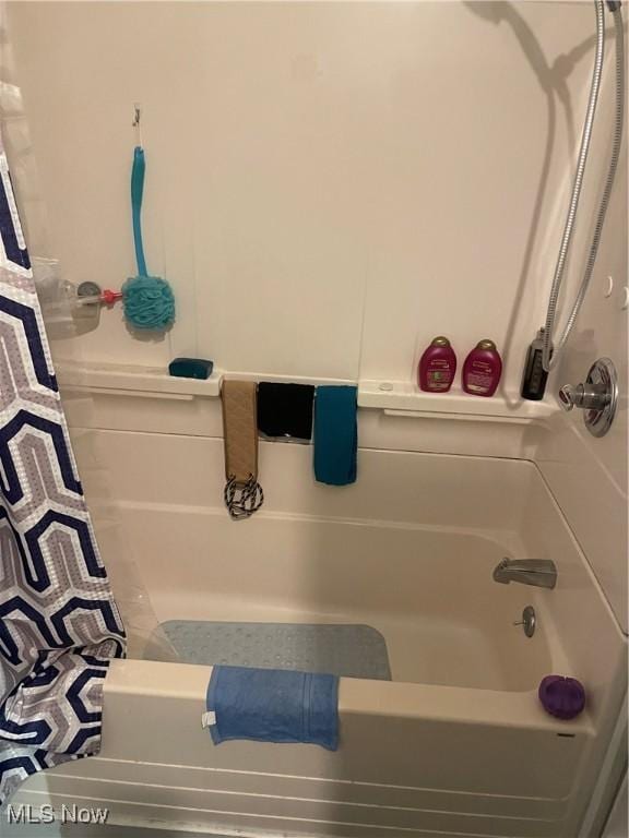 bathroom with shower / tub combo with curtain