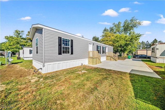 view of front of house with a front lawn and a patio area