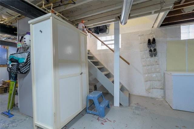 basement featuring refrigerator and electric panel