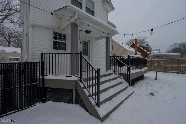 view of snow covered property entrance