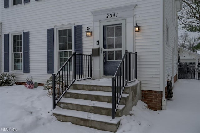 view of snow covered property entrance