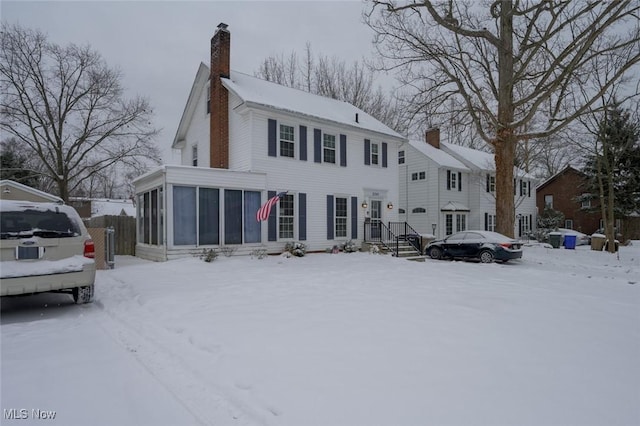 view of front of house featuring a sunroom