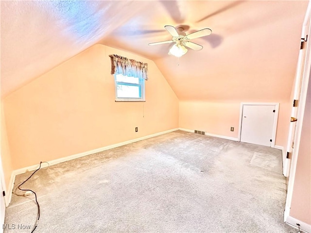 additional living space featuring vaulted ceiling, ceiling fan, and carpet