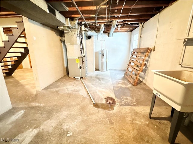 basement with water heater, heating unit, and sink