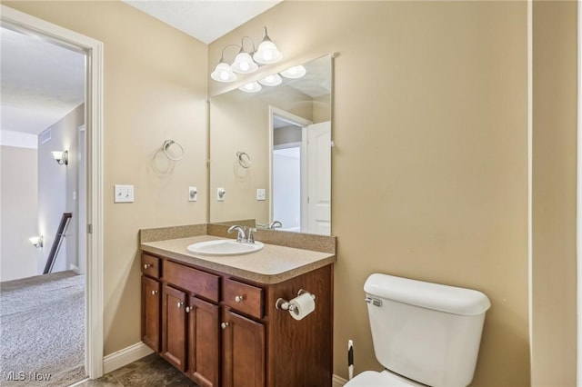 bathroom with toilet and vanity