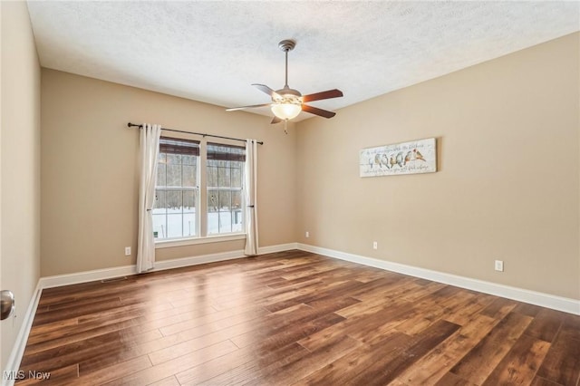 spare room with ceiling fan, dark hardwood / wood-style floors, and a textured ceiling