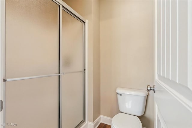 bathroom featuring toilet and walk in shower