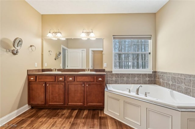 bathroom featuring vanity, a bathing tub, and hardwood / wood-style floors