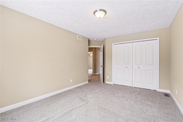 unfurnished bedroom with a closet and carpet floors