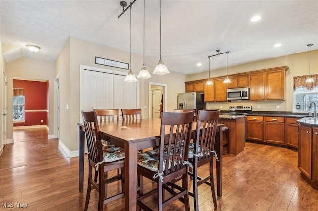 dining room with dark hardwood / wood-style floors and sink