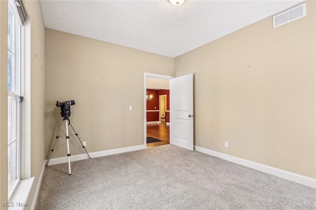 unfurnished room with carpet flooring