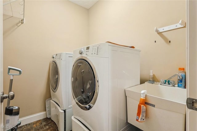 clothes washing area with sink and separate washer and dryer