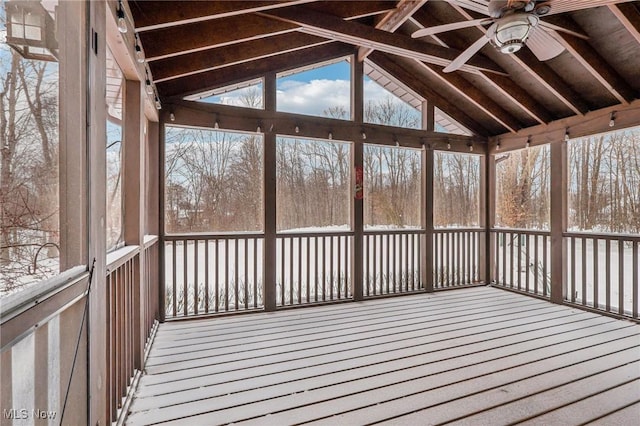 unfurnished sunroom featuring ceiling fan