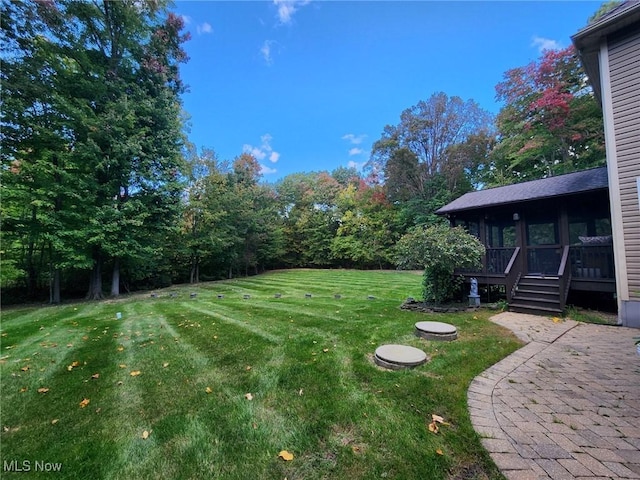 view of yard with a patio and a sunroom