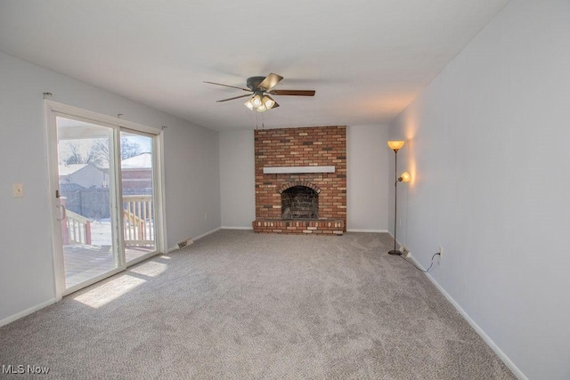 unfurnished living room featuring ceiling fan, carpet, and a fireplace