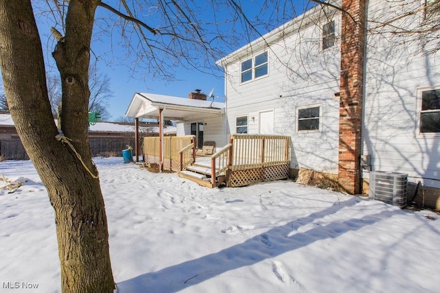 snow covered house featuring a deck and central air condition unit