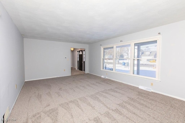 unfurnished room featuring carpet