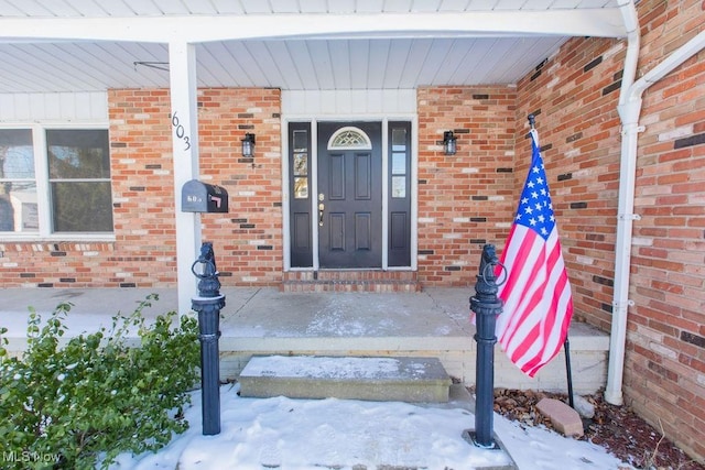 view of snow covered property entrance