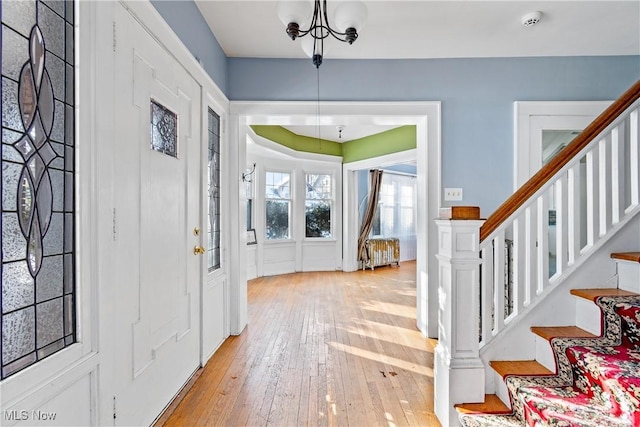 foyer featuring light wood-type flooring and stairs