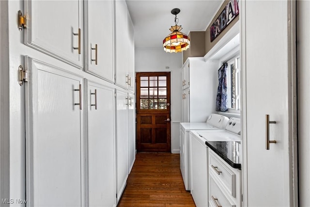 laundry area with washer and clothes dryer, cabinet space, and dark wood finished floors