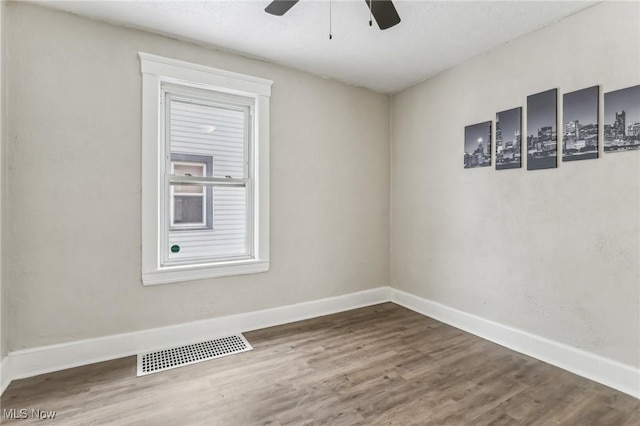 spare room featuring ceiling fan and hardwood / wood-style flooring