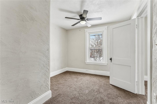 carpeted empty room featuring ceiling fan