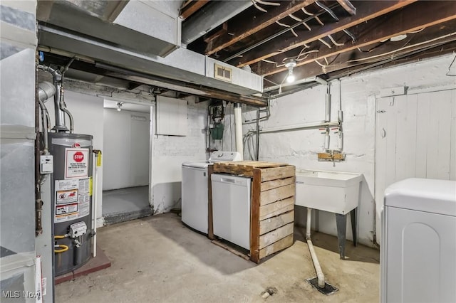 basement with water heater and washing machine and dryer