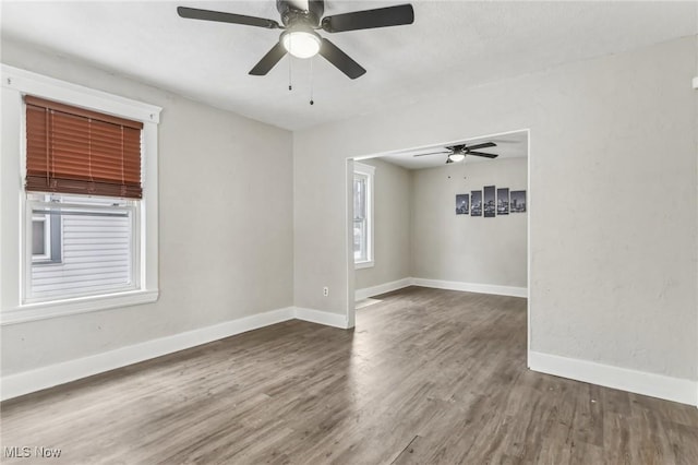 unfurnished room with dark wood-type flooring and ceiling fan