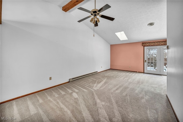 carpeted spare room featuring ceiling fan, baseboard heating, and lofted ceiling with skylight