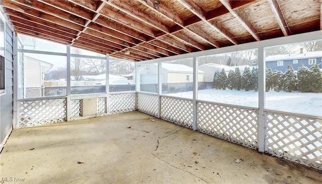 unfurnished sunroom featuring lofted ceiling