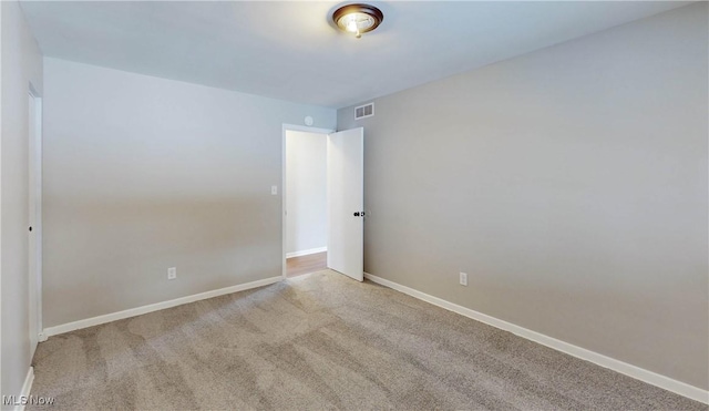 unfurnished room with light colored carpet