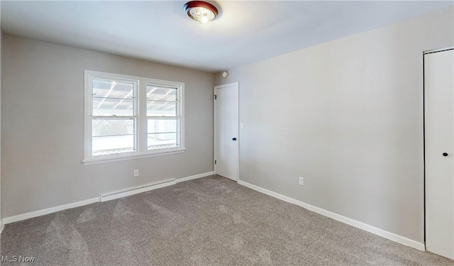 carpeted empty room with baseboard heating